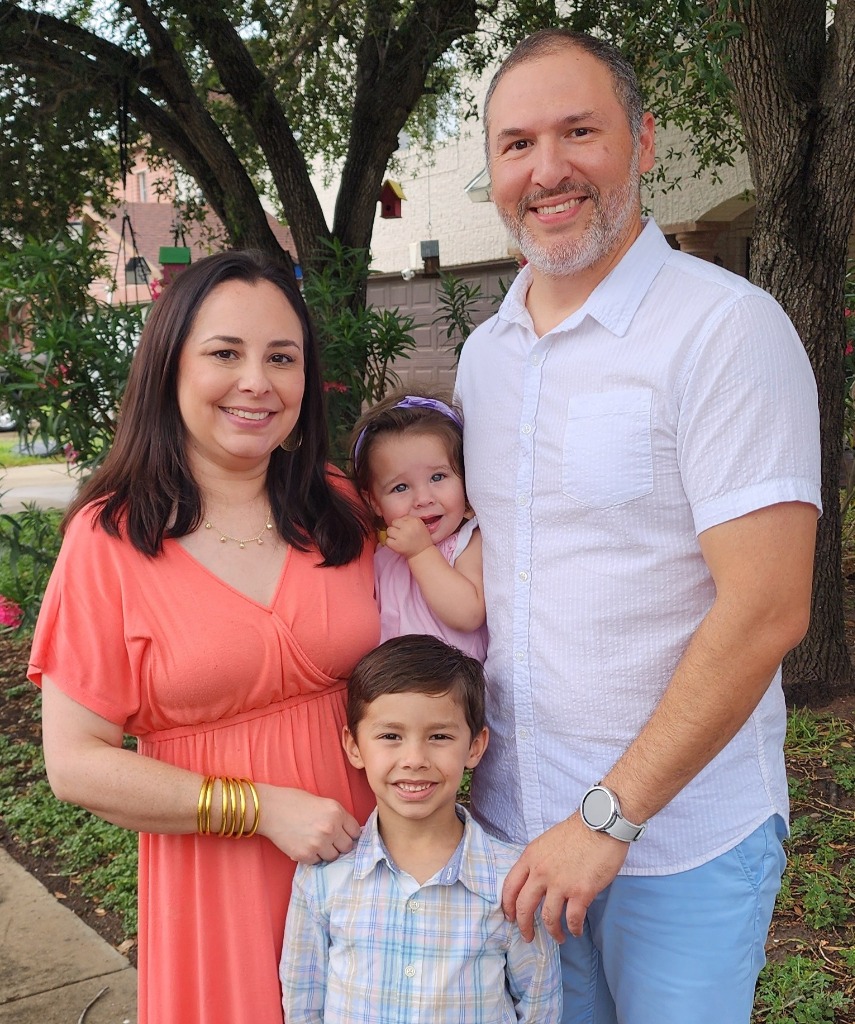 Jeremiah with his family outside the office